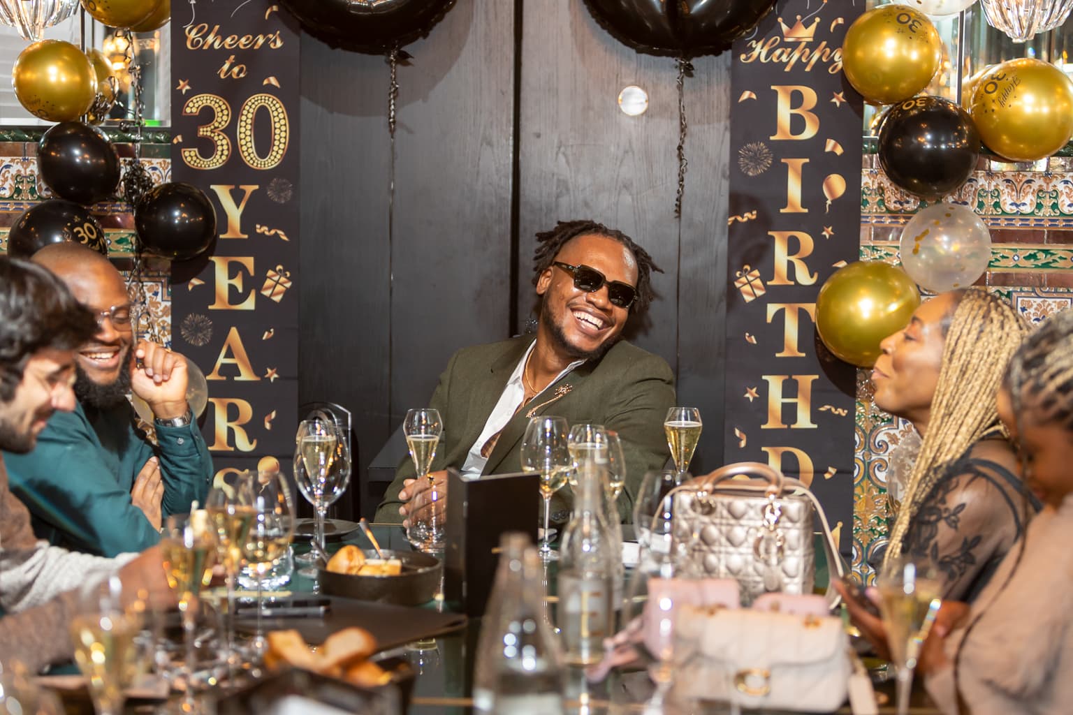 Tochii laughing with friends during birthday dinner