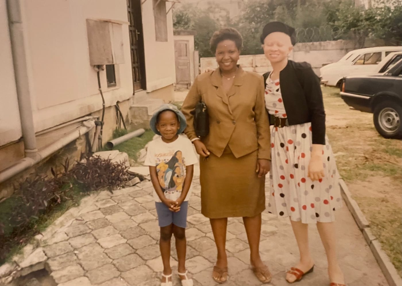 Tochii’s mum, centre, in a brown suit, standing with family in Nigeria